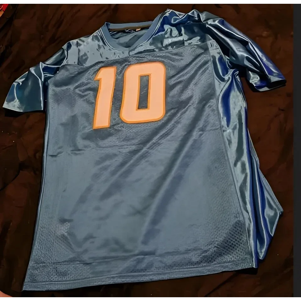 Light blue Justin Herbert autographed jersey with number 10 and certificate of authenticity