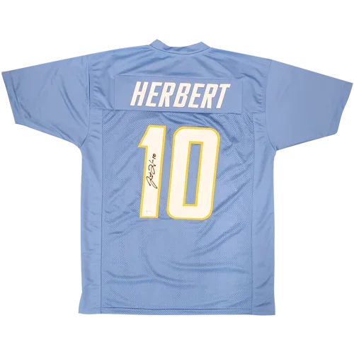 Back of a powder blue mesh football jersey with herbert 10 in white outlined in yellow and justin herbert autographed signature
