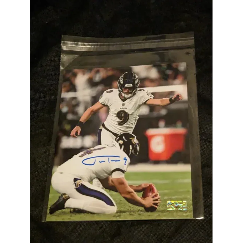 Autographed 8x10 Justin Tucker signed Ravens photo of kicker and holder in uniforms