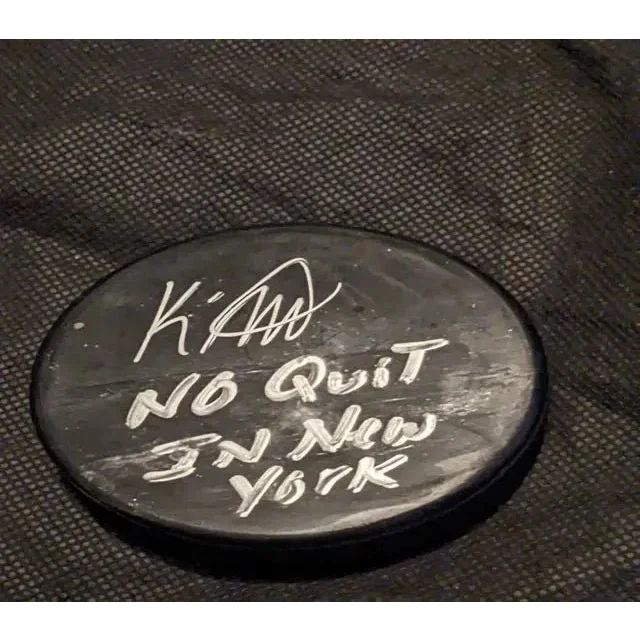Black hockey puck with white handwritten signature from KAndre Miller auto signed hockey puck