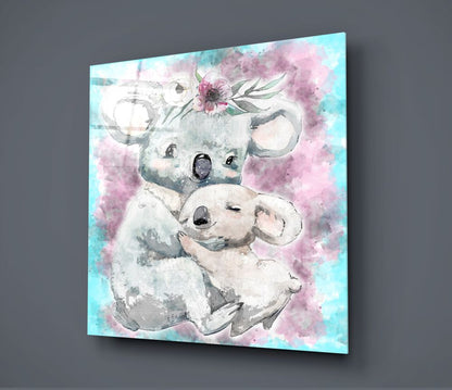 Glass wall art displaying a watercolor mother koala holding a baby koala with pink flowers and turquoise background.