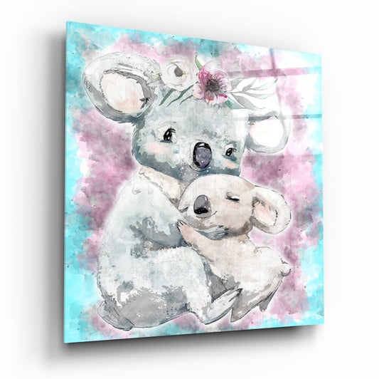 Angled view of glass wall art depicting a mother koala holding a baby koala with watercolor pink and turquoise background and floral details.