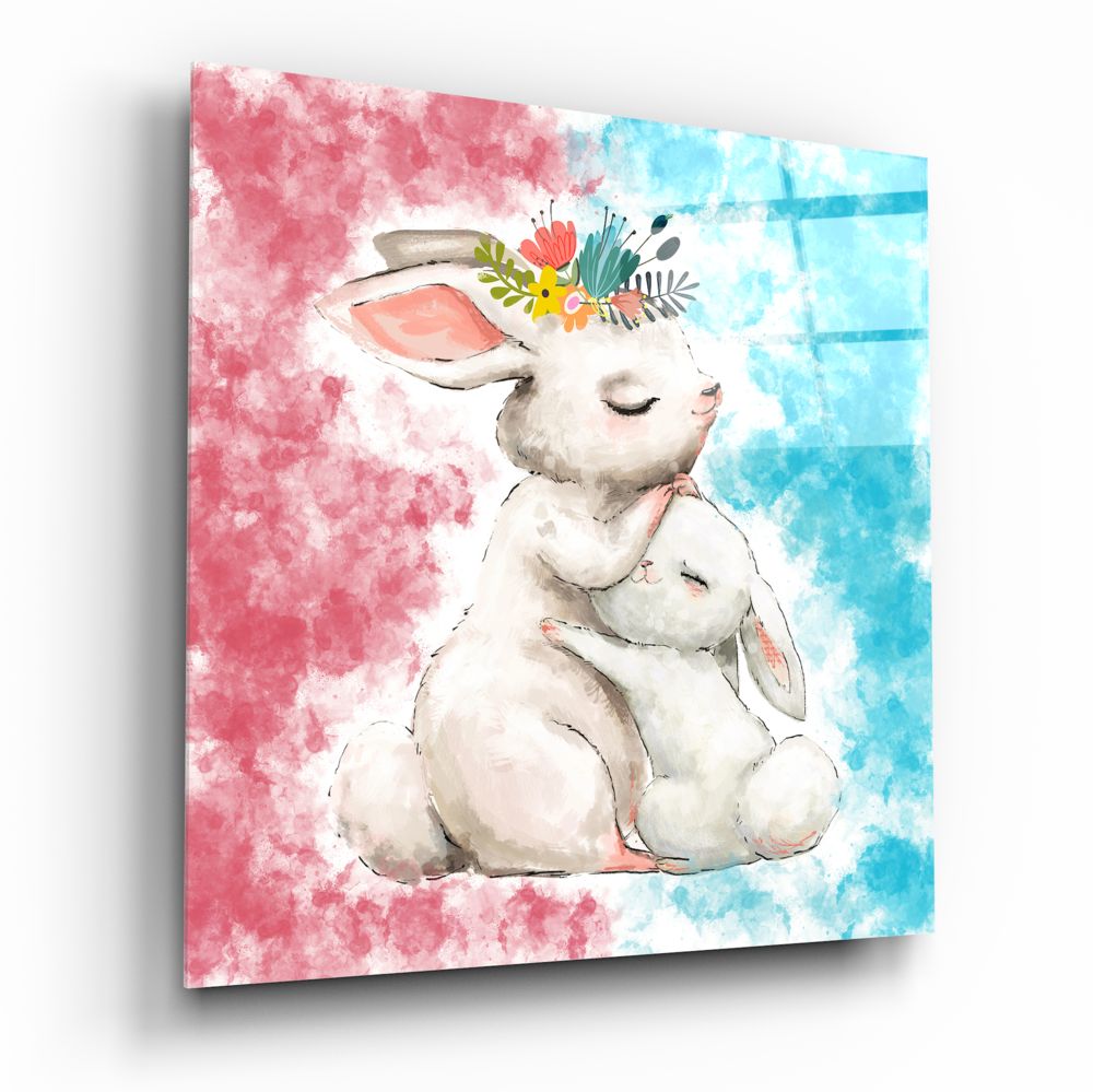 Glass wall art displaying a watercolor illustration of a white mother rabbit holding a small bunny, wearing a floral crown, against pink and blue watercolor backgrounds.