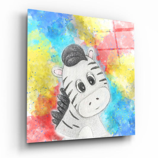 Angled view of glass wall art featuring a cartoon baby zebra illustration centered on a vibrant watercolor splatter background in blue, yellow, pink, and orange tones.