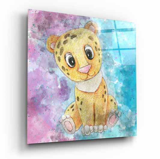 Glass wall art panel displaying a yellow spotted leopard cub with large eyes against pink and blue watercolor background, angled perspective view.