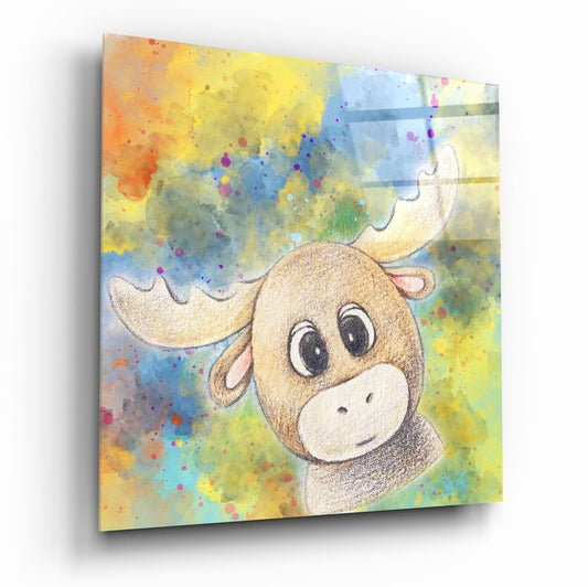 Angled view of glass wall art featuring a smiling moose with large eyes against a watercolor background of yellow, blue, and multicolored paint splatters.
