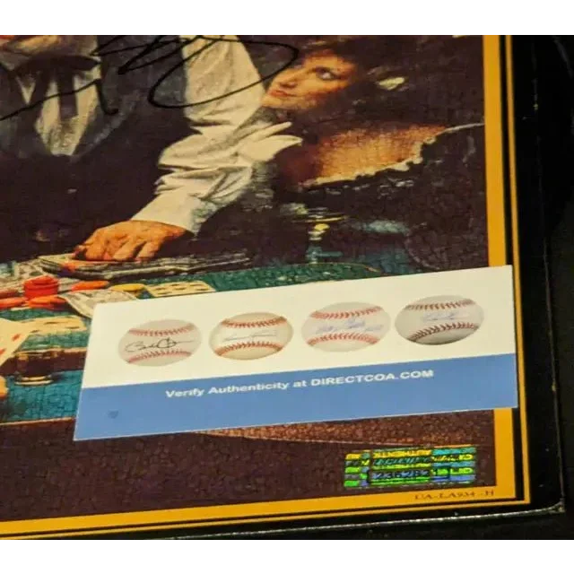 Kenny Rogers autographed Gambler album cover with authenticity certificate displayed