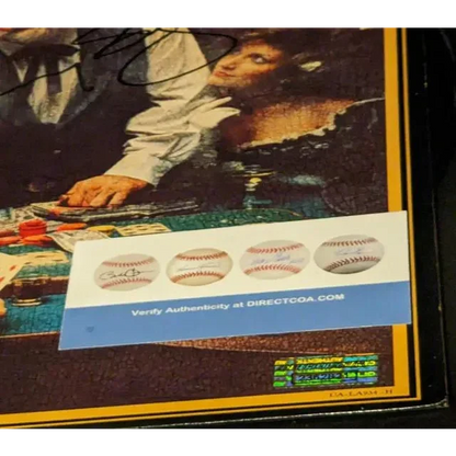 Kenny Rogers autographed Gambler album cover with authenticity certificate displayed