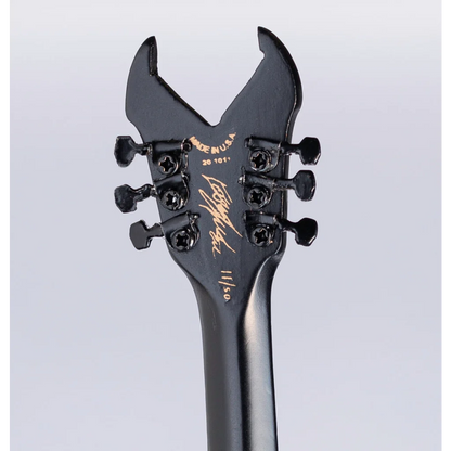 Black Jackson Kerry King guitar headstock with gold accents on Axe Heaven stand