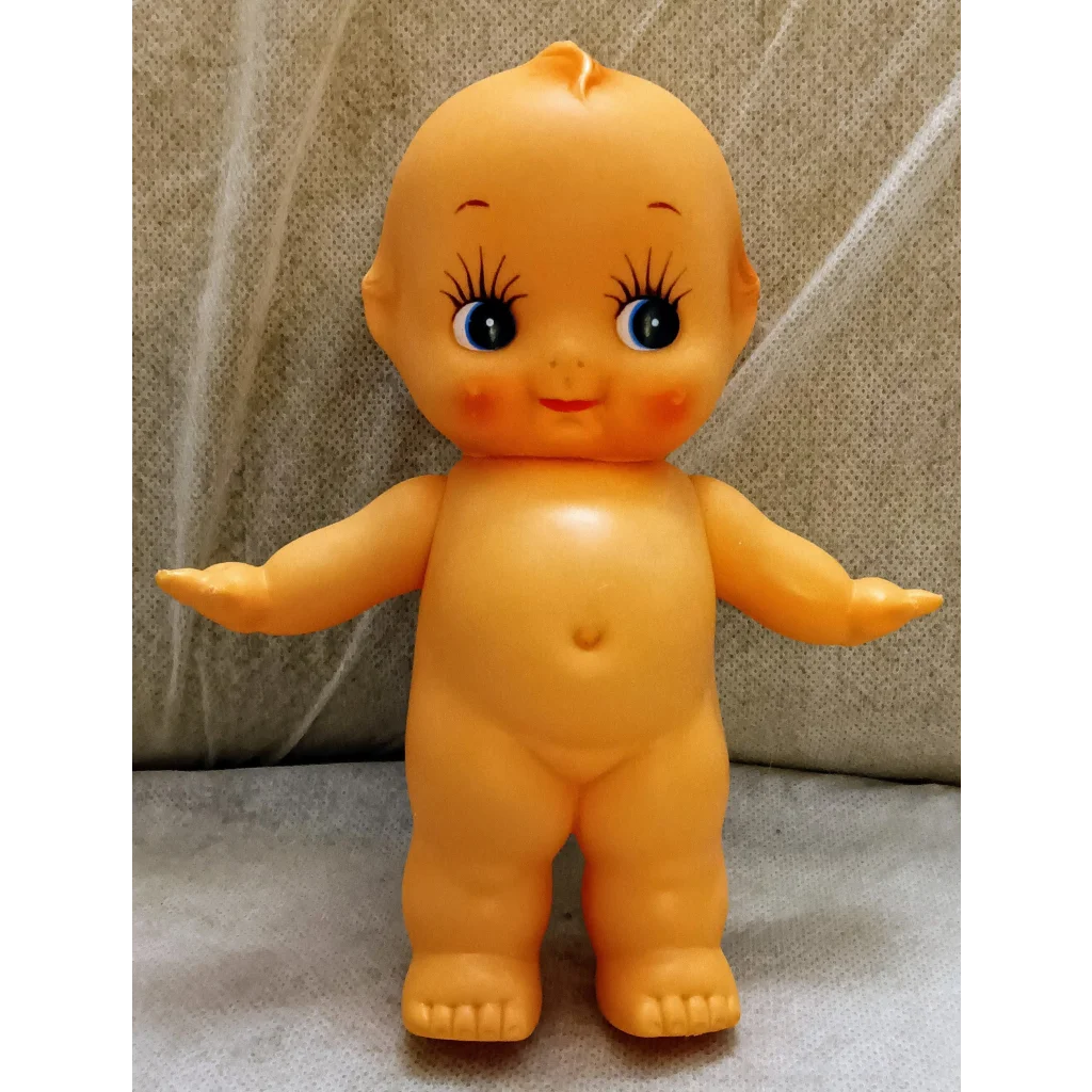 Vintage Kewpie Doll in orange plastic with angel wings and smiling face