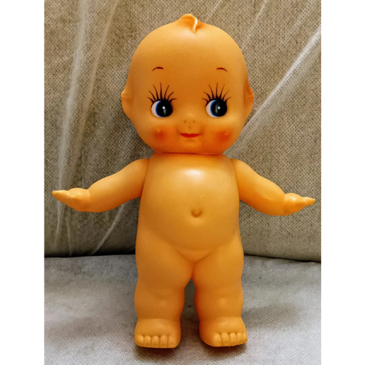Vintage Kewpie Doll in orange plastic with angel wings and smiling face