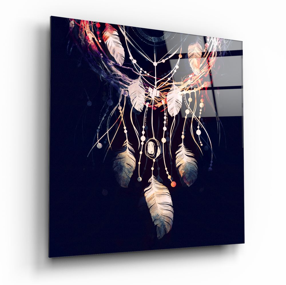 Dreamcatcher glass wall art with feathers and beads against dark navy background, displayed at angled perspective.
