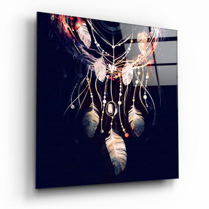 Dreamcatcher glass wall art with feathers and beads against dark navy background, displayed at angled perspective.