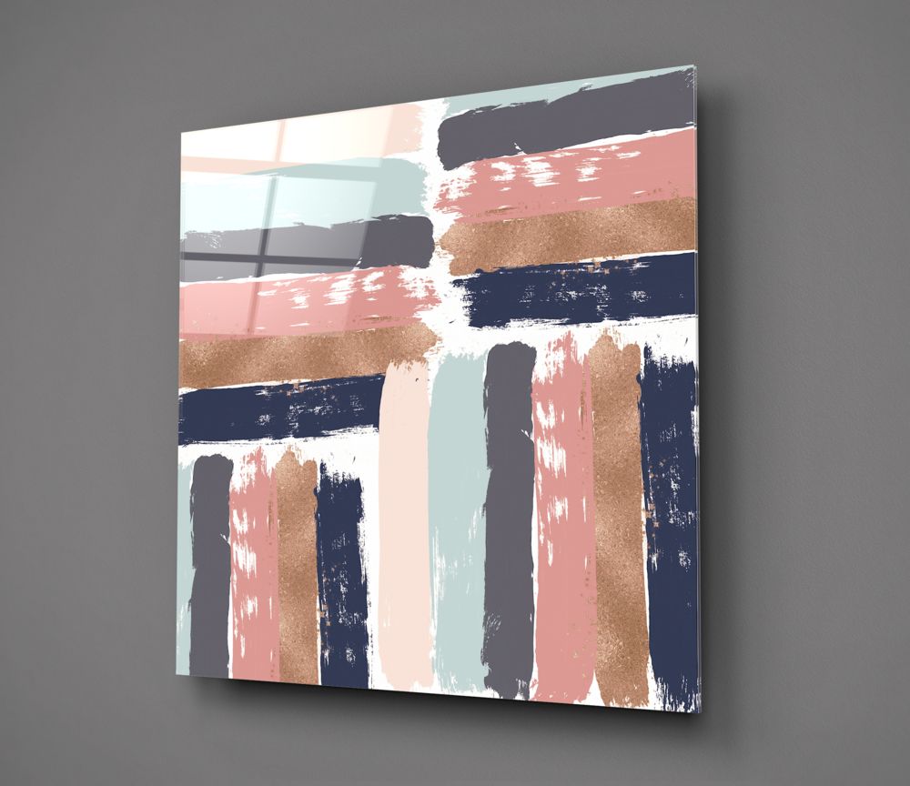Modern glass wall art displaying horizontal and vertical brushstrokes in coral, navy, gold, and pale blue against white background, photographed at angle.