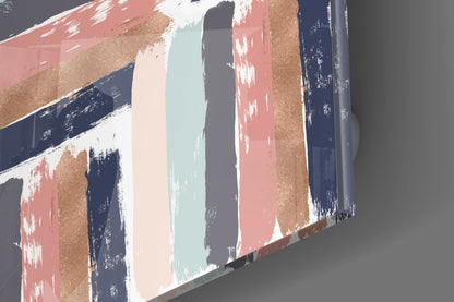 Close-up angled view of glass wall art showing vertical brush strokes in navy, coral, gold, cream, and pale blue with distressed white highlights.