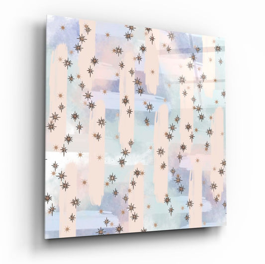 Angled perspective of glass wall art featuring brown and copper stars scattered across soft watercolor washes in cream, blue, and lavender.