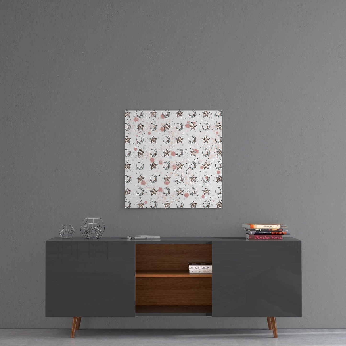 Moon and star patterned glass wall art hanging above a mid-century modern console table against gray wall.