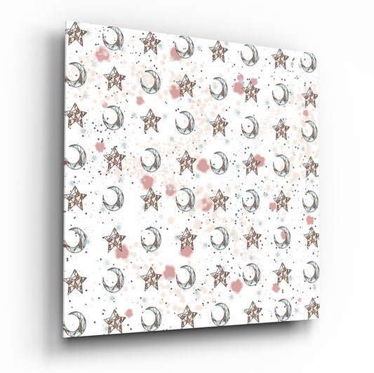 Angled perspective view of glass wall art displaying repeating pattern of brown stars and crescent moons with pink and blue watercolor splashes on white background.
