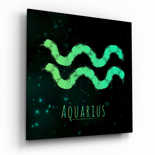 Angled front view of glass wall art displaying bright green brushstroke Aquarius symbol with scattered cyan starlight on black background.