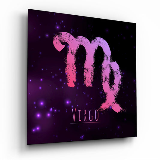 Angled perspective view of glass wall art displaying pink brushstroke Virgo symbol on dark purple nebula background with glowing blue stars.