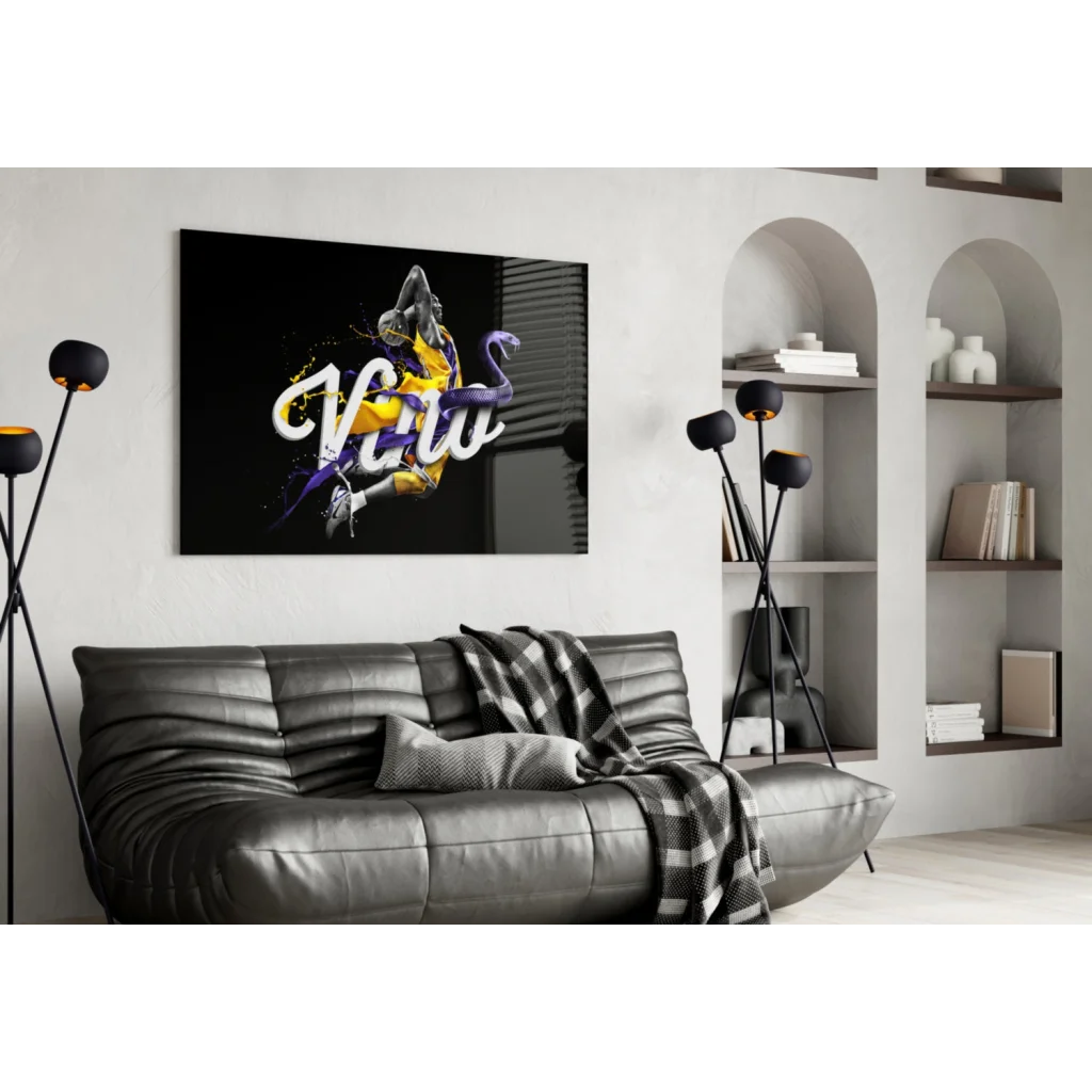 Kobe Bryant poster wall art on black leather couch with checkered blanket