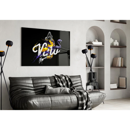 Kobe Bryant poster wall art on black leather couch with checkered blanket