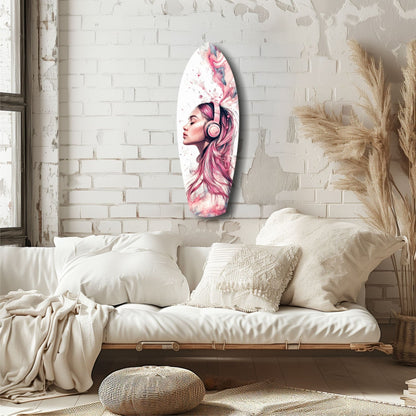 Oval glass wall art featuring pink-haired woman with headphones and watercolor florals, displayed above cream bedding in minimalist bedroom.