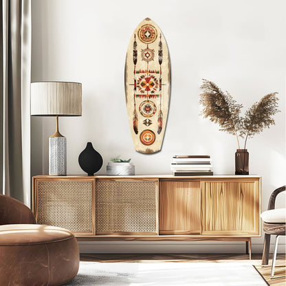 Cream-colored surfboard-shaped wall art with geometric Native American patterns in red, orange, and brown displayed above a wooden credenza in a modern living room.