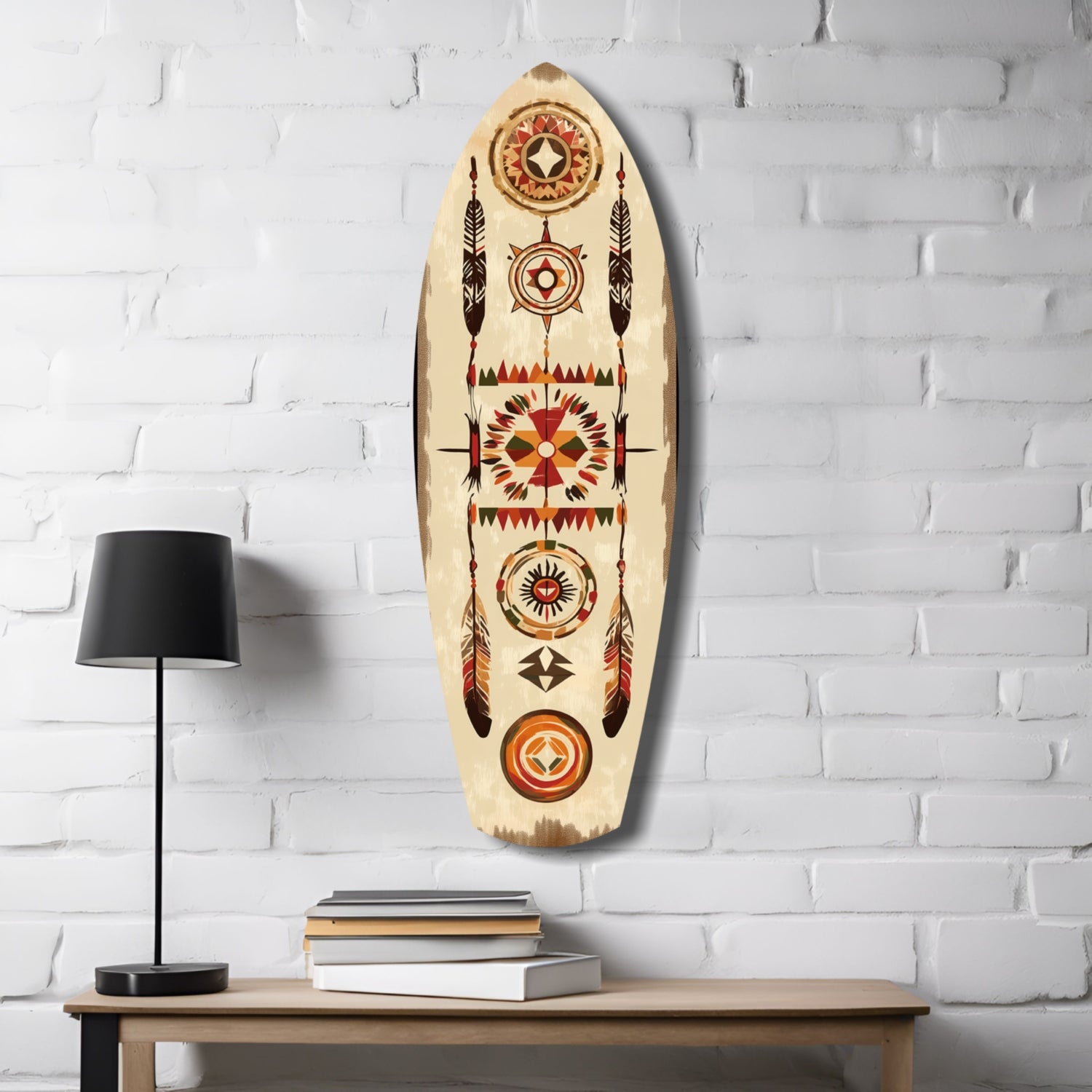 Aztec-patterned wooden surfboard wall art hanging above wooden table with black lamp and stacked books.