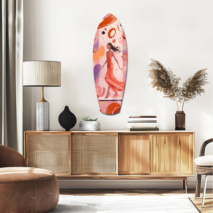 Colorful surfboard-shaped glass wall art featuring a woman in red dress displayed above wooden mid-century modern credenza in contemporary living room setting.