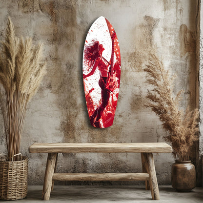Red and white glass wall art depicting a musician with guitar, displayed above wooden bench in minimalist interior setting.