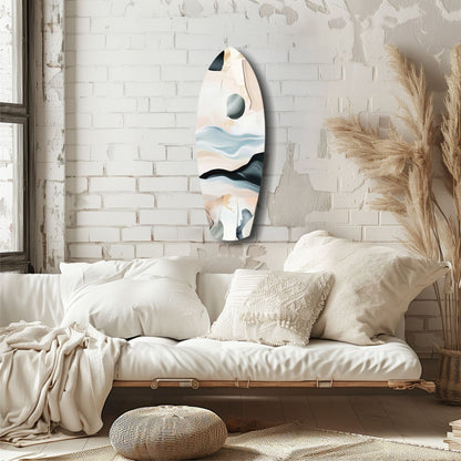 Abstract sailing glass wall art with layered blue, black, and cream tones displayed above a cream bedroom sofa.