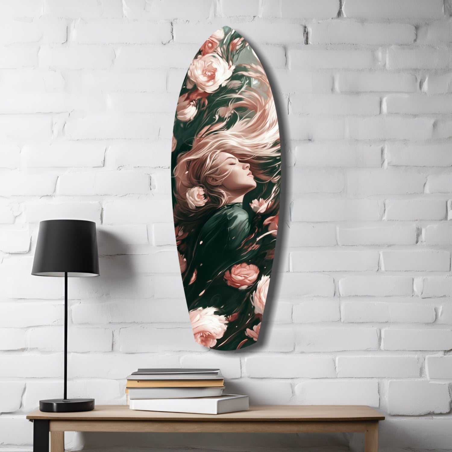 Oval glass wall art featuring a woman's profile surrounded by pink and red roses on dark green background, displayed above wooden table with lamp and books.