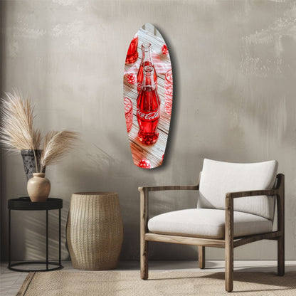 Vintage Coca-Cola glass wall art hung above wooden chair in minimalist room setting with decorative vase and side table.