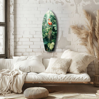Oval glass wall art depicting a red flamingo surrounded by green tropical foliage, displayed on white brick wall above a cream upholstered daybed.