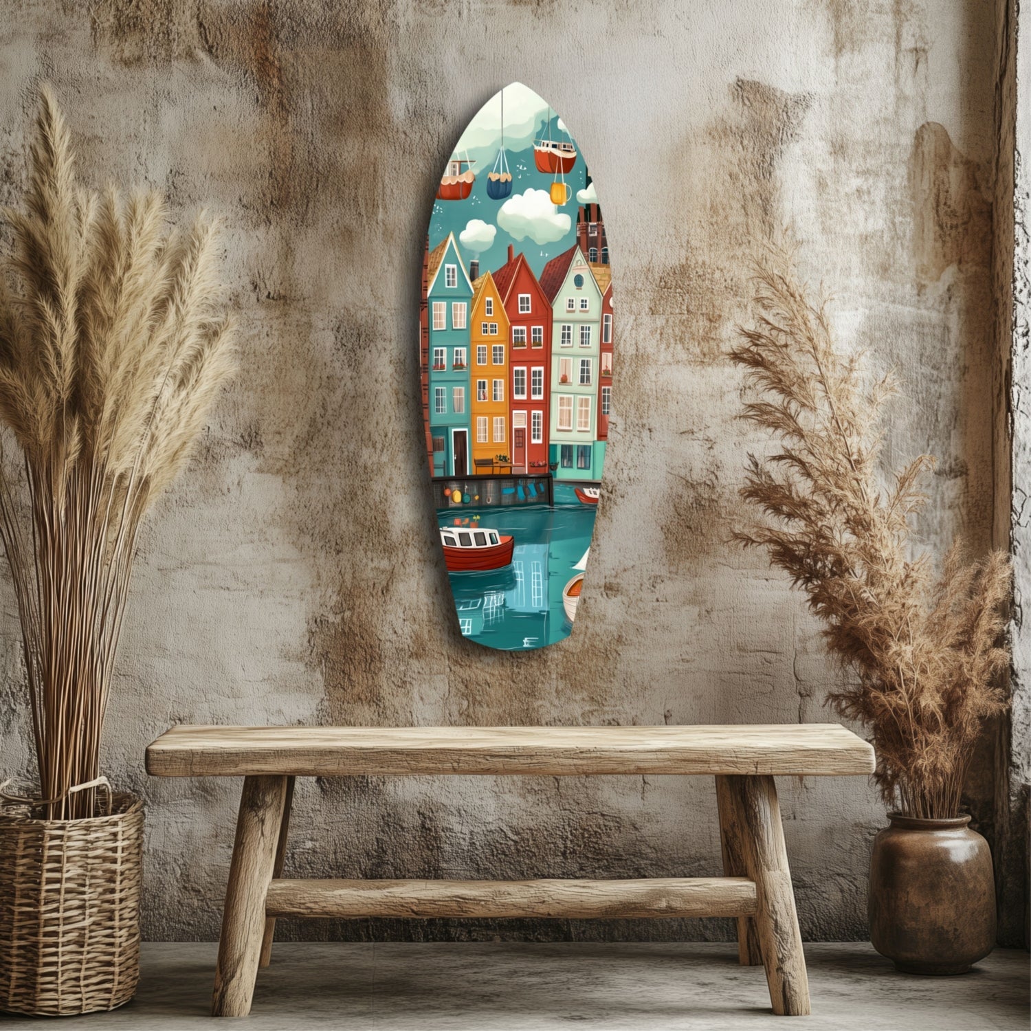 Oval glass wall art depicting colorful waterfront houses and boats displayed on textured concrete wall above wooden bench with dried pampas grass decoration.
