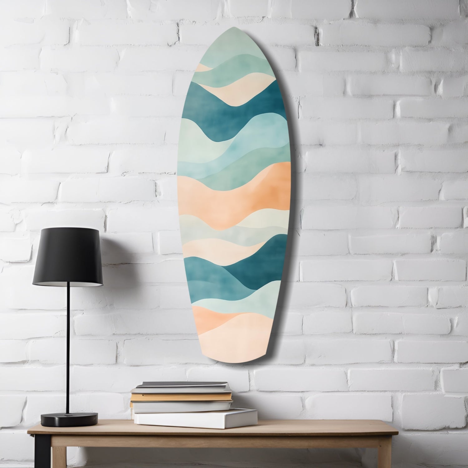 Oval sea glass wall art with layered wavy bands in teal, cream, and peach hung above wooden table with black lamp and stacked books.