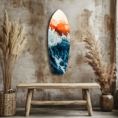 Surfboard-shaped glass wall art depicting ocean waves and sunset sky displayed above wooden bench in rustic room setting.