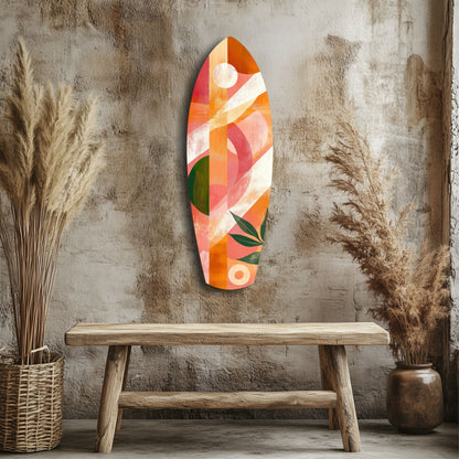 Colorful abstract glass wall art in orange, pink, coral, and green geometric patterns displayed above a wooden bench in a styled interior setting.