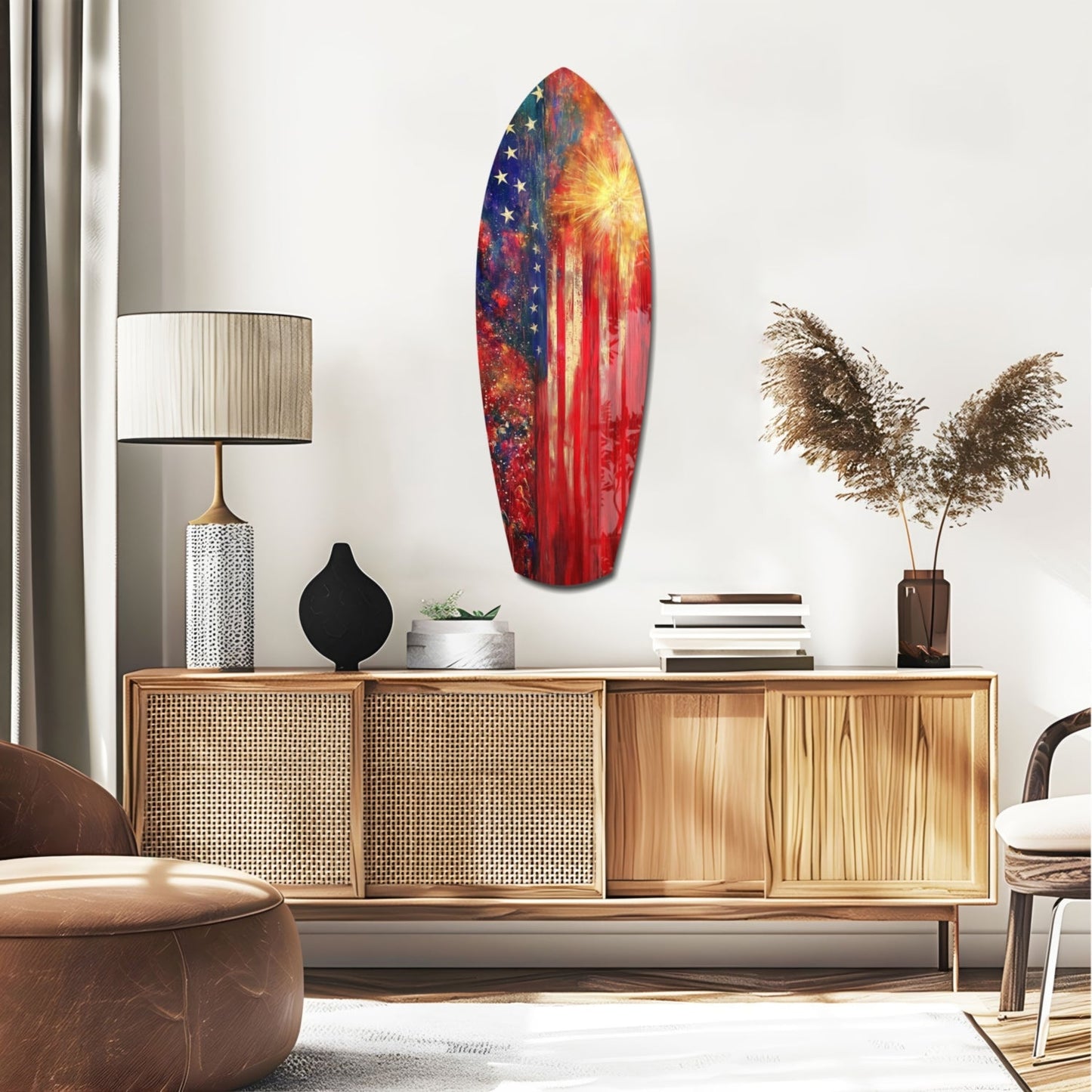 Patriotic surfboard-shaped glass wall art with red, blue, and gold sunburst design displayed above wooden credenza in modern interior setting.