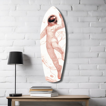Oval glass wall art depicting a floating astronaut in rose tones against white brick, displayed above a wooden desk with lamp and books.