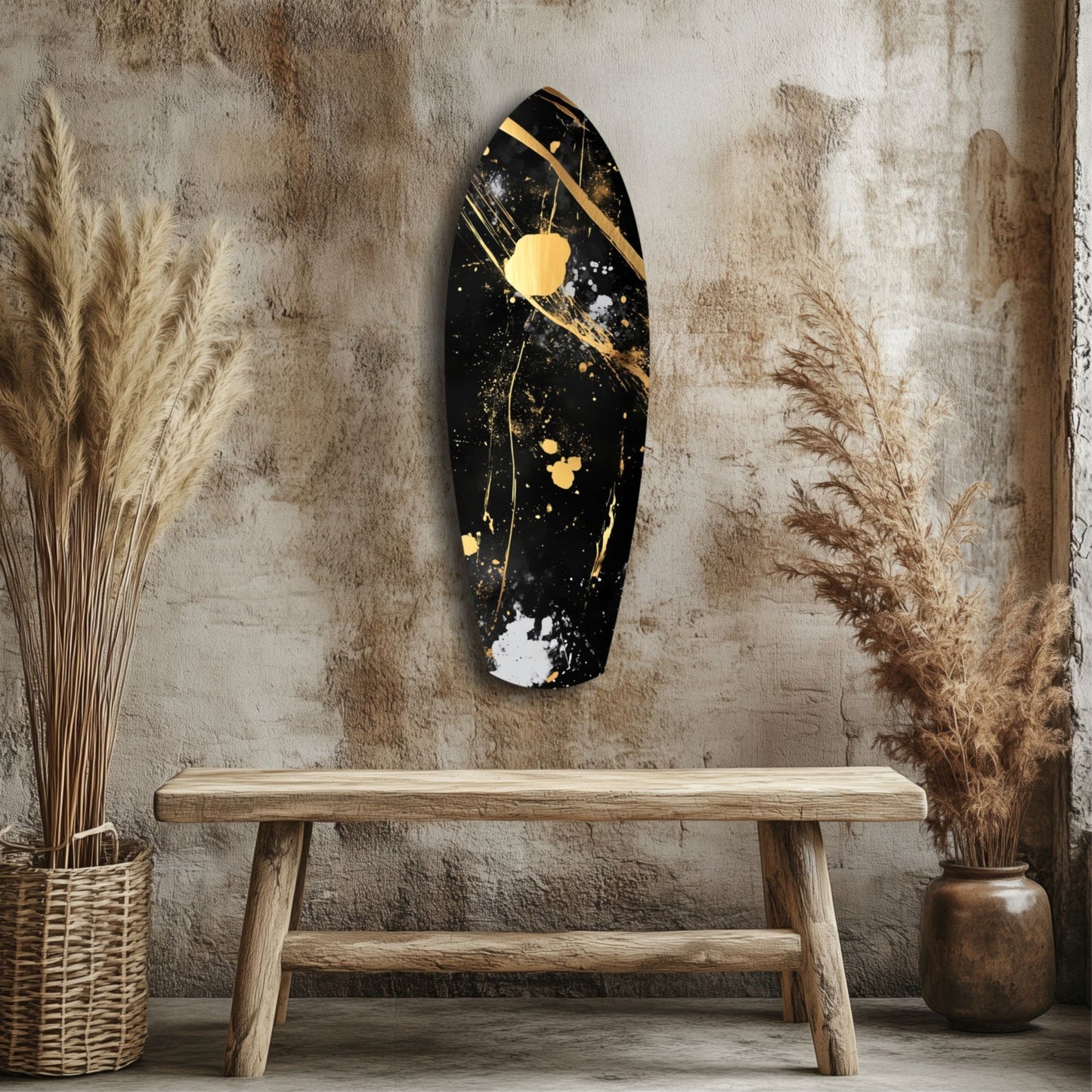 Black and gold abstract wall art mounted above wooden bench in rustic interior with dried grasses and textured wall.