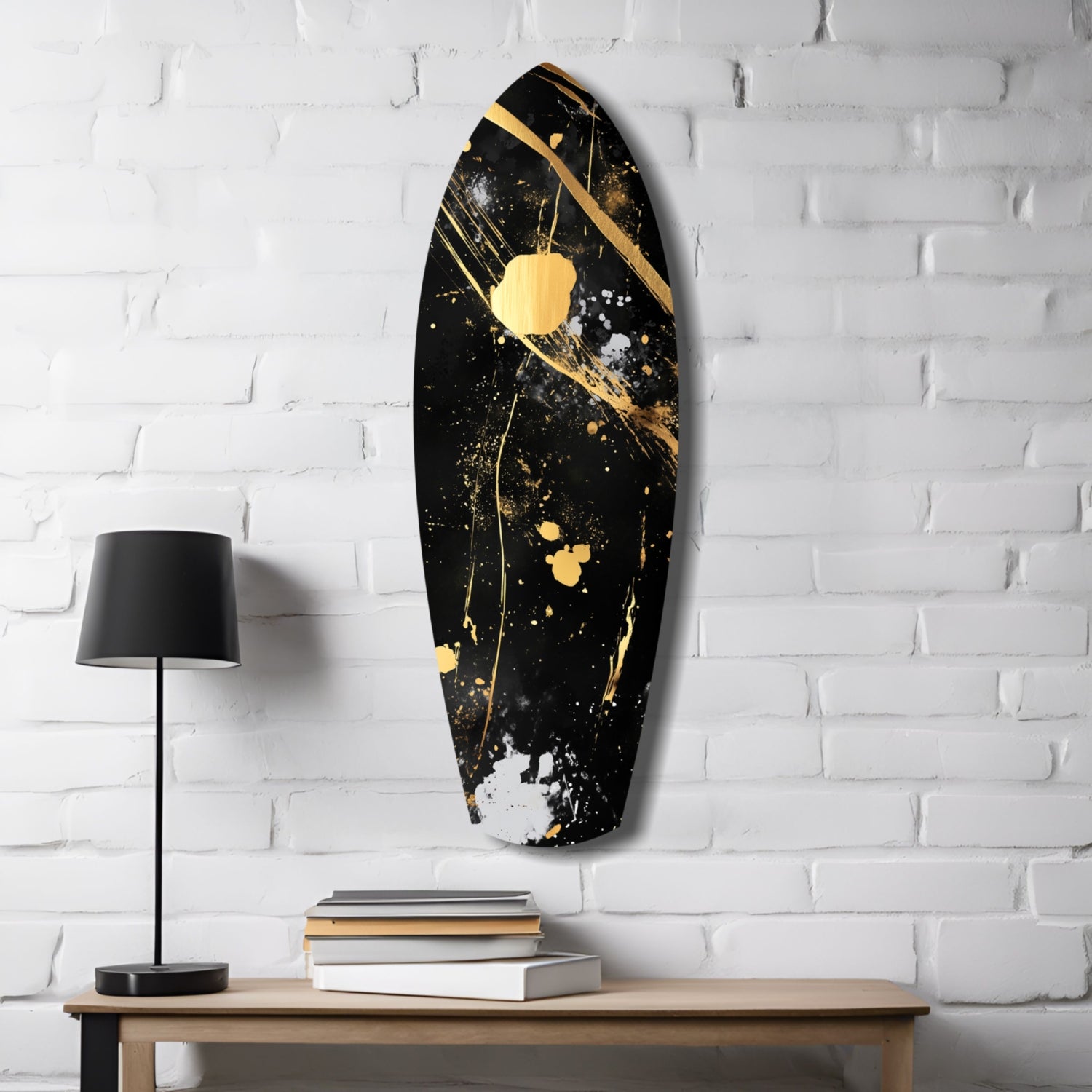 Black and gold stained glass wall art displayed above wooden table with lamp and stacked books against white brick wall.