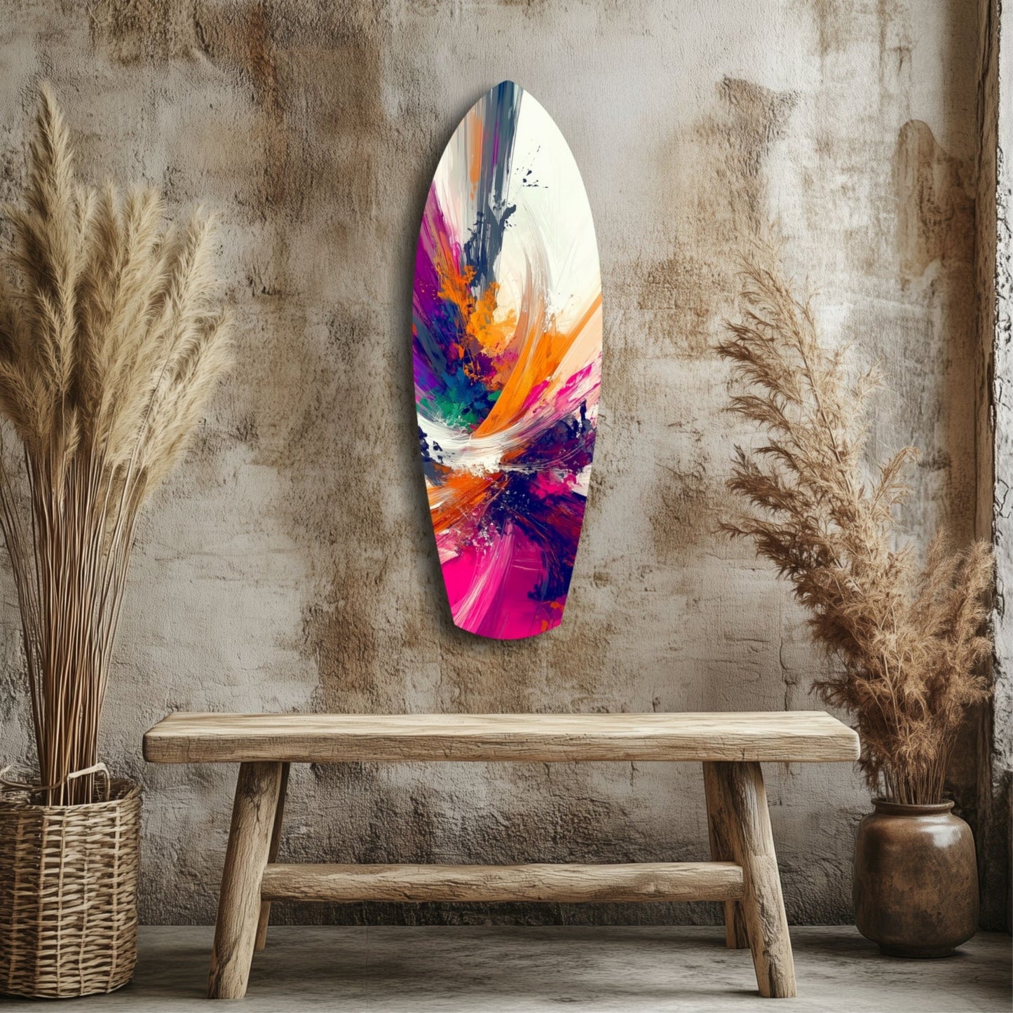 Colorful abstract glass art hanging on textured wall above wooden bench, surrounded by dried pampas grass in woven baskets.