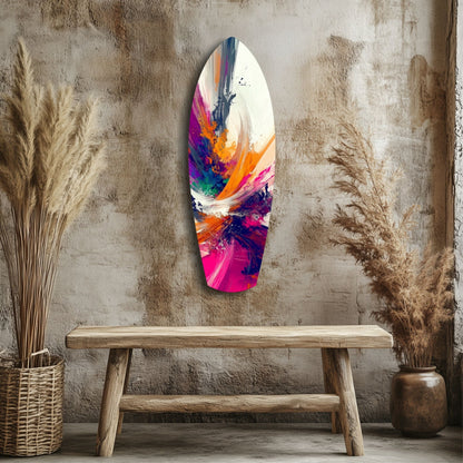 Colorful abstract glass art hanging on textured wall above wooden bench, surrounded by dried pampas grass in woven baskets.