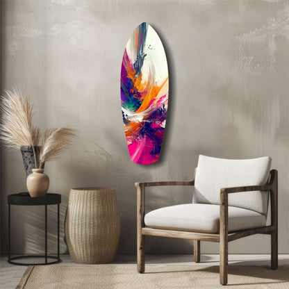 Colorful abstract paint brush glass wall art displaying vibrant pink, orange, blue, and purple strokes hung above a wooden chair in a modern living room setting.