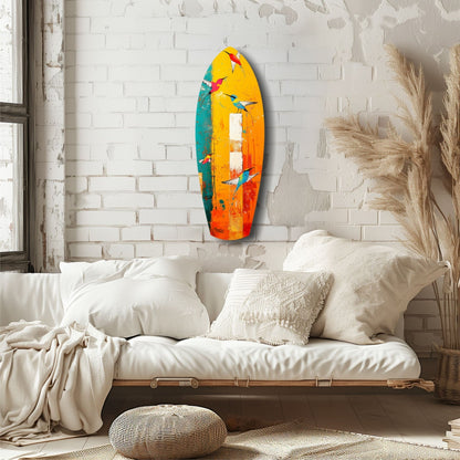 Colorful glass wall art featuring yellow, orange, teal, and red hues with bird designs, displayed above a cream-upholstered daybed in a minimalist bedroom.
