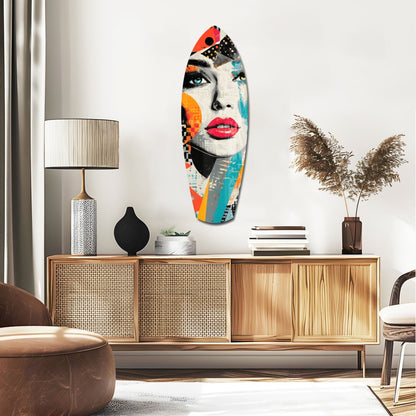 Colorful pop art glass wall art featuring a woman's face with bold red lips, blue eyes, and multicolored geometric patterns displayed above a wooden sideboard.