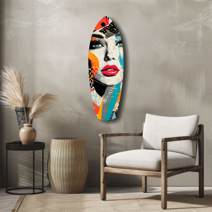 Colorful pop art glass wall art depicting a woman's face with bold red lips and multicolored geometric patterns, displayed above a wooden chair in a minimalist interior.