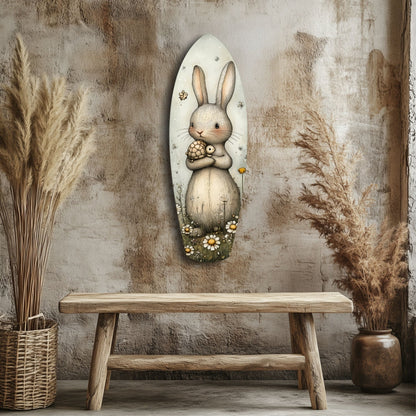 Cute rabbit glass wall art mounted above wooden bench, surrounded by dried pampas grass and woven baskets against textured wall.